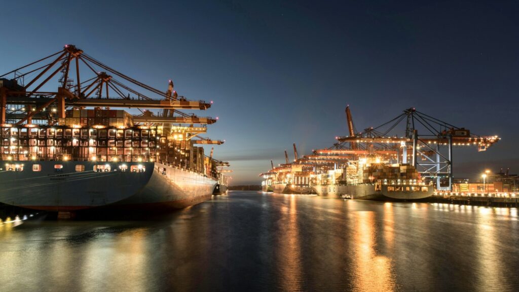 Port at golden hour, gantry cranes against the sky